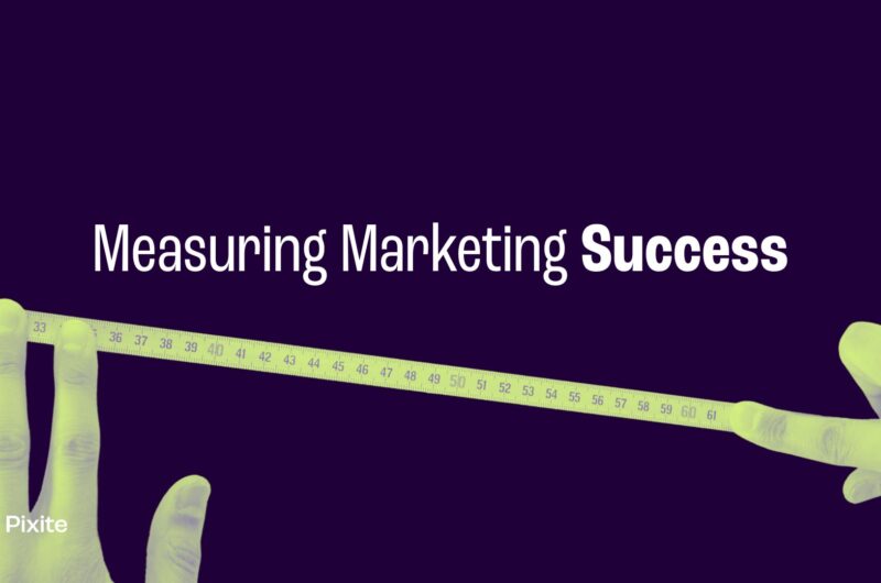 Image of two hands holding a measuring tape with the text "Measuring Marketing Success" on a dark background.